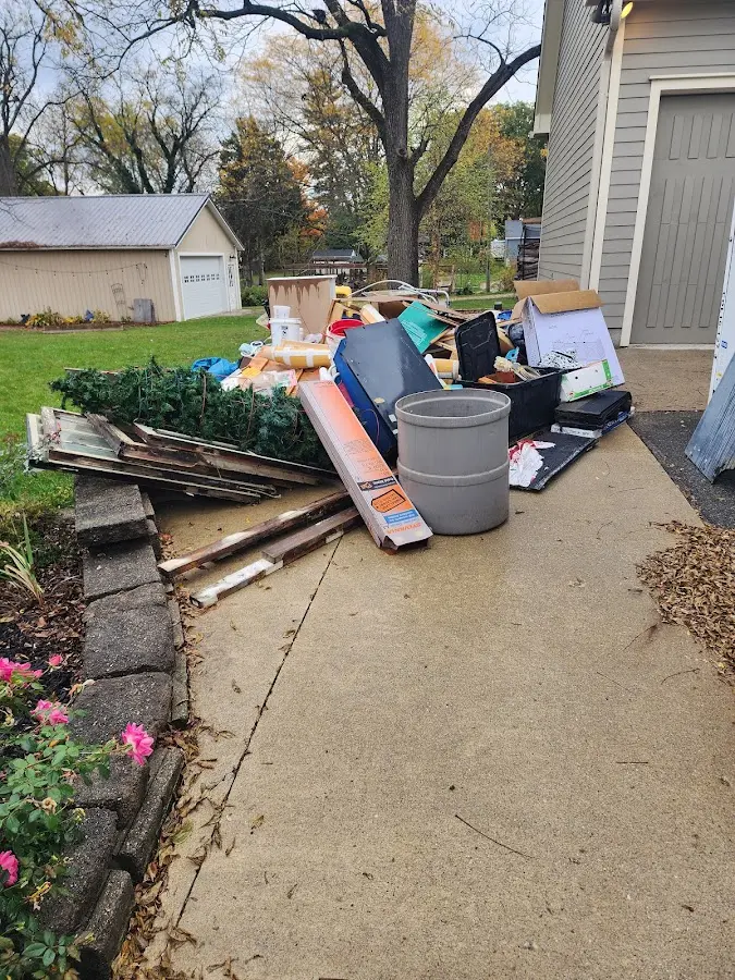 Dumpster being loaded with debris for Estate Cleanout Dumpster Rental in Denmark